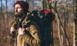 young-hipster-man-traveling-with-backpack-autumn-forest-wearing-warm-jacket-hat_285396-9782.jpg