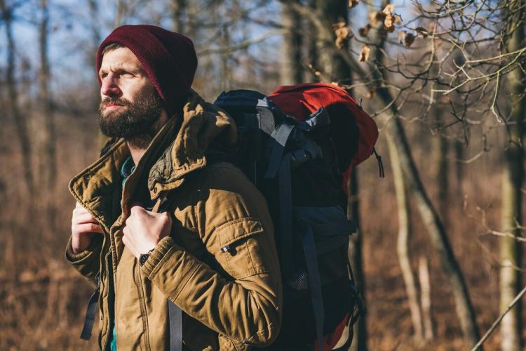 young-hipster-man-traveling-with-backpack-autumn-forest-wearing-warm-jacket-hat_285396-9782.jpg