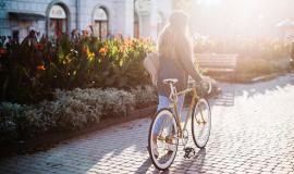 unrecognizable-woman-walking-with-bicycle-in-park_23-2147713914.jpg