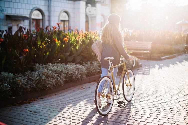 unrecognizable-woman-walking-with-bicycle-in-park_23-2147713914.jpg