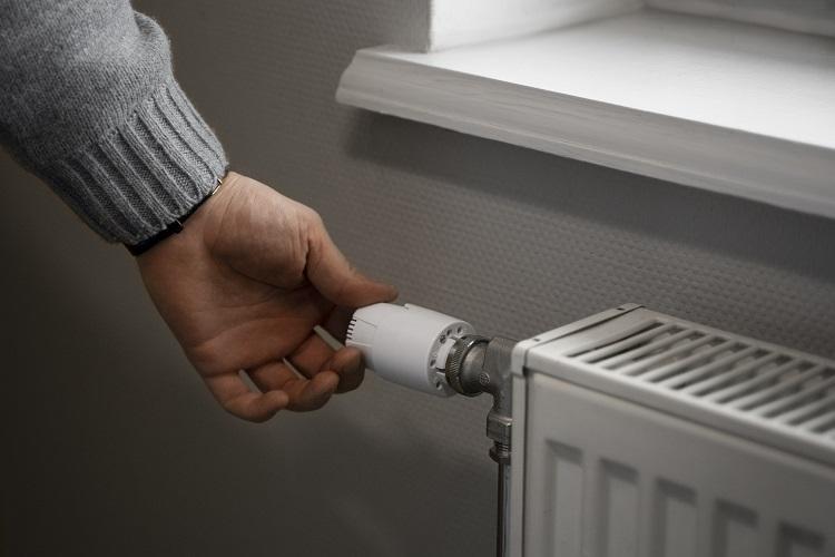 man-turning-off-radiator-during-energy-crisis.jpg