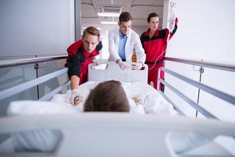 doctors-pushing-emergency-stretcher-bed-corridor_107420-63719.jpg