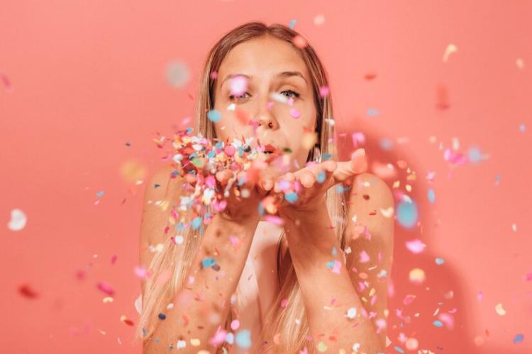 girl-blowing-confetti_23-2148123049.jpg