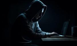 hooded-burglar-typing-crime-dark-laptop-generated-by-ai_188544-26179.jpg