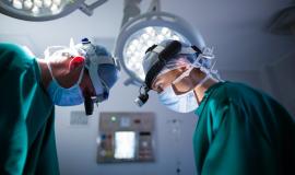 surgeons-wearing-surgical-loupes-while-performing-operation_107420-64896.jpg