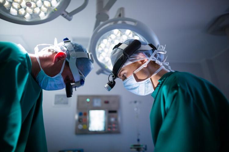 surgeons-wearing-surgical-loupes-while-performing-operation_107420-64896.jpg