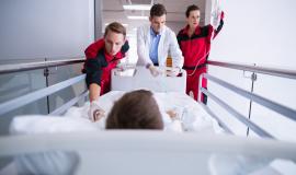 doctors-pushing-emergency-stretcher-bed-corridor_107420-63719.jpg