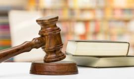 wooden-gavel-and-books-on-wooden-table.jpg