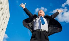 excited-businessman-raising-his-arms-against-sky_23-2147956326.jpg