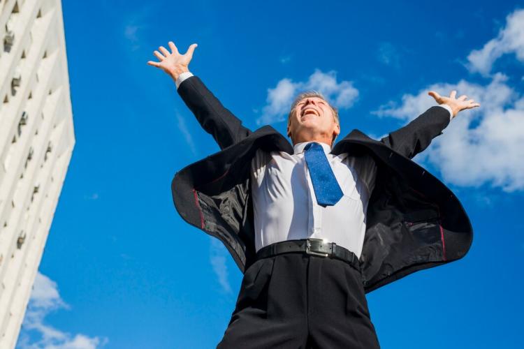 excited-businessman-raising-his-arms-against-sky_23-2147956326.jpg