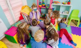 young-engaged-teacher-sitting-with-group-preschool-children-floor-during-lesson-process-learning-can-be-fun-room-with-colorful-mats-floor-multicolor-furniture_290431-24389.jpg