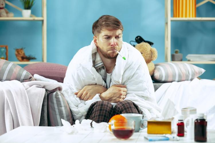 bearded-sick-man-with-flue-sitting-sofa-home-measuring-body-temperature-winter-illness-influenza-pain-concept-relaxation-home-healthcare-concepts_155003-31685.jpg