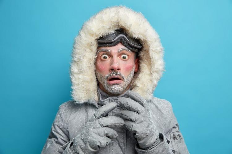 frozen-male-explorer-has-red-face-covered-with-frost-stares-very-shocked-surprised-by-very-low-temperature-wears-warm-jacket-gloves-has-walk-outdoor-during-blizzard-cold-weather_273609-47045.jpg