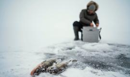 man-getting-ready-fishing-frozen-lake_23-2148853228.jpg