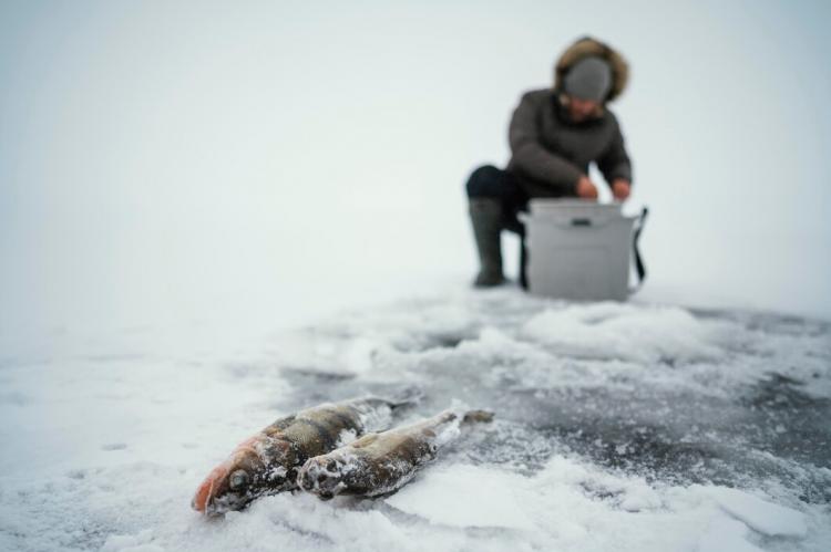 man-getting-ready-fishing-frozen-lake_23-2148853228.jpg