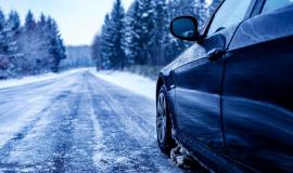 black-car-iced-road-surrounded-by-trees-covered-with-snow_181624-42123.jpg