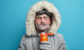 puzzled-frozen-man-winter-clothes-tries-warm-himself-with-hot-beverage-has-red-face-bear-covered-with-blizzard-spends-much-time-outdoors-during-snowboarding-frosty-weather-conditions_273609-47051.jpg