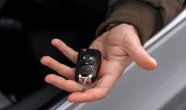 high-angle-hand-holding-car-key_23-2150320964.jpg