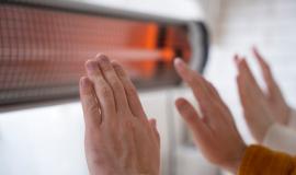 close-up-people-warming-up-hands-near-heater_23-2149339533.jpg