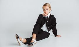little-girl-posing-school-s-uniform-white-studio-wall_155003-38311.jpg