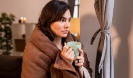 woman-holding-cup-coffee-while-being-covered-with-blanket_23-2148821621.jpg