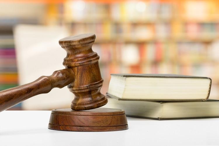 wooden-gavel-and-books-on-wooden-table.jpg