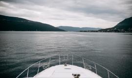 white-yacht-crosses-sea-leaving-mountains-with-fog-it_8353-8845.jpg