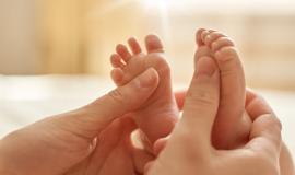 mum-making-baby-massage-mother-massaging-infant-bare-foot-preventive-massage-newborn-mommy-stroking-baby-s-feet-with-both-hands-light-background_176532-13965.jpg