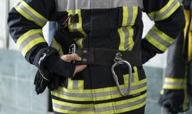 male-firefighter-getting-equipped-at-station.jpg