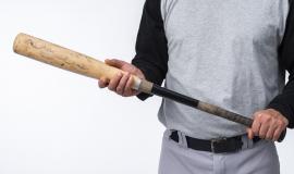 close-up-of-baseball-player-holding-bat.jpg