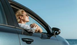 mid-shot-woman-car-looking-sea_23-2148756485.jpg