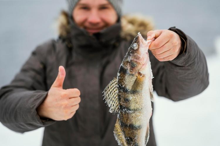 man-holding-victoriously-fish-he-caught_23-2148853202.jpg