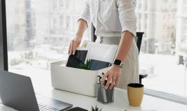 side-view-woman-packing-desk-items_23-2149480600.jpg