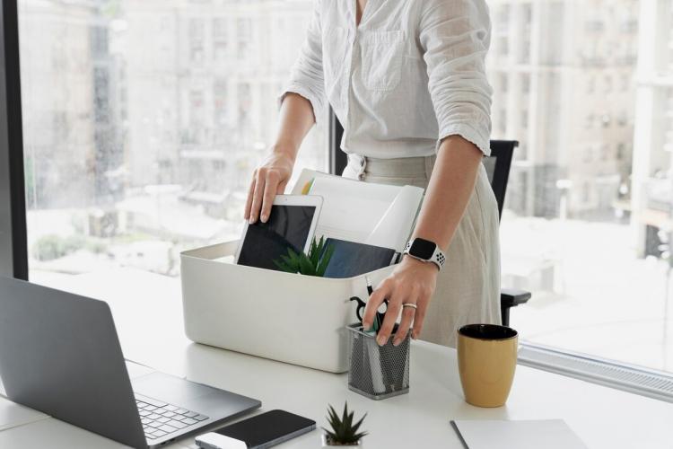 side-view-woman-packing-desk-items_23-2149480600.jpg