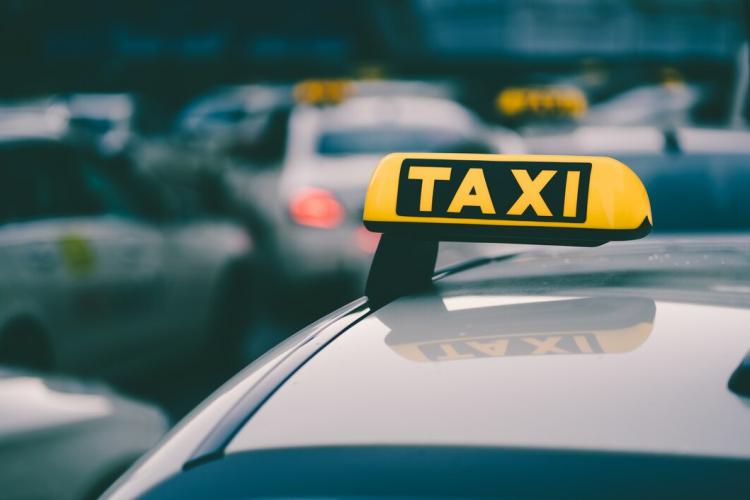 selective-focus-shot-yellow-taxi-sign-traffic-jam_181624-42635.jpg