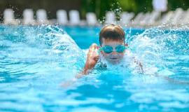 boy-goggles-swimming-splashing-pool_259150-60553.jpg