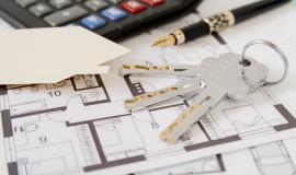 keys-fountain-pen-house-paper-cut-out-and-calculator-on-architectural-blueprints.jpg