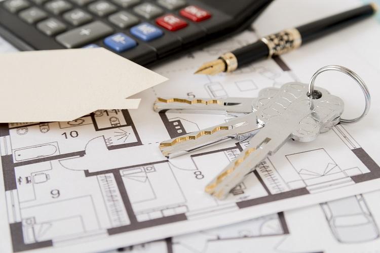 keys-fountain-pen-house-paper-cut-out-and-calculator-on-architectural-blueprints.jpg