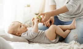 little-baby-boy-spending-happy-childhood-with-young-mother-child-trying-take-beautiful-toy-from-tender-mom-hands-family-concept_176420-12192.jpg