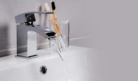 closeup-shot-of-water-flowing-from-a-basin-mixer-tap-in-the-bathroom.jpg