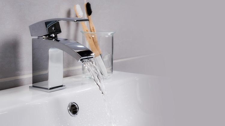 closeup-shot-of-water-flowing-from-a-basin-mixer-tap-in-the-bathroom.jpg