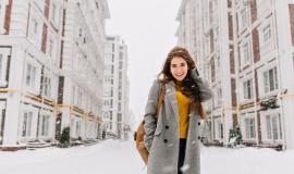 charming-young-woman-in-coat-with-long-brunette-hair-enjoying-snowfall-in-big-city-cheerful-emotions-smiling-christmas-mood-positive-face-emotions-winter-weather-place-for-text.jpg