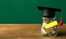 front-view-of-jar-with-coins-and-academic-cap_23-2148756627.jpg