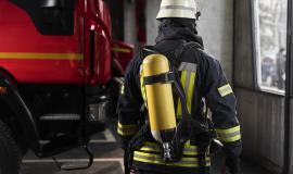 firefighter-at-the-station-with-suit-and-safety-helmet.jpg