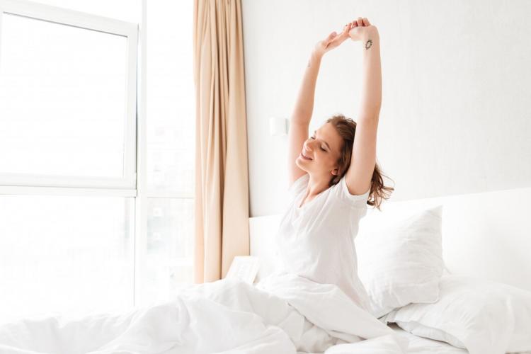 young-woman-in-bed-indoors-stretching_171337-13228.jpg