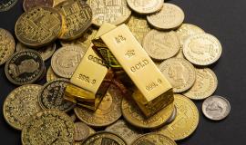 coins-gold-bars-scattered-table.jpg